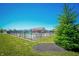 Community pool surrounded by a black metal fence, lawn and a clubhouse at 6218 N Woodside Ct, McCordsville, IN 46055