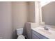 A clean and simple powder room with a modern white vanity and standard toilet at 6218 N Woodside Ct, McCordsville, IN 46055