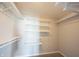 This walk-in closet includes wall to wall metal shelving at 6218 N Woodside Ct, McCordsville, IN 46055