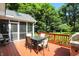 Back deck featuring an outdoor table with seating and a gas grill, with a large backyard and trees at 6316 Harmonridge Ct, Indianapolis, IN 46278