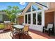 Back deck featuring a gas grill and outdoor table with seating, with large windows into the home at 6316 Harmonridge Ct, Indianapolis, IN 46278