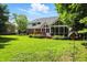 Expansive backyard showing the home's deck, sunroom, and lush landscaping at 6316 Harmonridge Ct, Indianapolis, IN 46278