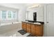 Bathroom features double sinks, a jacuzzi tub, and a large window for natural light at 6316 Harmonridge Ct, Indianapolis, IN 46278