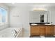 Well-lit bathroom features double sinks, a jacuzzi tub and vanity with storage space at 6316 Harmonridge Ct, Indianapolis, IN 46278