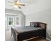 Bedroom featuring vaulted ceilings, carpet, a ceiling fan, and a large window at 6316 Harmonridge Ct, Indianapolis, IN 46278