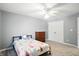 A cozy bedroom featuring carpet, a ceiling fan, and closet for ample storage at 6316 Harmonridge Ct, Indianapolis, IN 46278