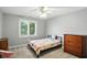Bright bedroom with a large window, ceiling fan, and light gray carpet, creating a cozy space at 6316 Harmonridge Ct, Indianapolis, IN 46278