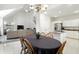 Bright dining area with a large table, hardwood chairs, and open floor plan leading to living room and kitchen at 6316 Harmonridge Ct, Indianapolis, IN 46278