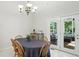 Cozy dining room with access to patio, showcasing a wooden table with chairs at 6316 Harmonridge Ct, Indianapolis, IN 46278