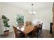 Bright dining room with wood flooring and elegant chandelier lighting at 6316 Harmonridge Ct, Indianapolis, IN 46278