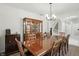 Dining room with a large wooden table, china cabinet, and elegant chandelier at 6316 Harmonridge Ct, Indianapolis, IN 46278