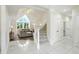 Spacious foyer with staircase and a living room featuring large windows at 6316 Harmonridge Ct, Indianapolis, IN 46278