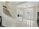 Grand foyer with white staircase, a striking front door, and marble floors at 6316 Harmonridge Ct, Indianapolis, IN 46278