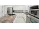 Modern kitchen with white cabinets, stainless steel appliances, and a countertop range perfect for cooking enthusiasts at 6316 Harmonridge Ct, Indianapolis, IN 46278