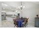 Spacious kitchen with white cabinetry, a center island, stainless steel appliances, and adjacent dining area at 6316 Harmonridge Ct, Indianapolis, IN 46278