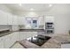 Bright kitchen with white cabinetry, granite countertops, stainless steel appliances, and modern fixtures at 6316 Harmonridge Ct, Indianapolis, IN 46278