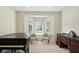 Living room area with neutral chairs, piano, bay window, and decorative dark wood cabinet at 6316 Harmonridge Ct, Indianapolis, IN 46278