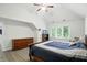Comfortable bedroom features a vaulted ceiling, hardwood floors, dresser storage and a view of the outdoors at 6316 Harmonridge Ct, Indianapolis, IN 46278