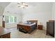 Spacious main bedroom featuring a vaulted ceiling, hardwood floors, and a large window for natural light at 6316 Harmonridge Ct, Indianapolis, IN 46278