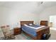Bright bedroom showcasing vaulted ceiling, hardwood floors, and a cozy chair for relaxing at 6316 Harmonridge Ct, Indianapolis, IN 46278