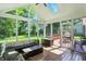 Well-lit screened porch with comfortable seating and views of the lush green yard at 6316 Harmonridge Ct, Indianapolis, IN 46278