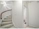 Carpeted staircase features a curved wood railing and natural light from a wall-mounted light fixture at 6316 Harmonridge Ct, Indianapolis, IN 46278