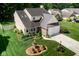 Aerial view showcasing the home's manicured lawn, landscaping, and convenient two-car garage at 6439 Bower Dr, Indianapolis, IN 46241