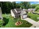 Aerial view of a home with a beautifully landscaped yard, driveway, and surrounding trees at 6439 Bower Dr, Indianapolis, IN 46241