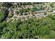 An aerial shot shows the layout of homes in a suburban neighborhood with dense tree coverage at 6439 Bower Dr, Indianapolis, IN 46241