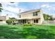 A manicured lawn and enclosed patio highlight the home's backyard at 6439 Bower Dr, Indianapolis, IN 46241