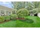 Landscaped backyard featuring a lush lawn and an enclosed patio at 6439 Bower Dr, Indianapolis, IN 46241