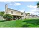 Spacious backyard with enclosed patio and manicured lawn and white picket fence at 6439 Bower Dr, Indianapolis, IN 46241