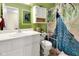 Bathroom featuring a vanity, toilet with safety bars, and a peacock-themed shower curtain at 6439 Bower Dr, Indianapolis, IN 46241