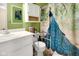 Bathroom featuring a vanity, toilet with safety bars, and a peacock-themed shower curtain at 6439 Bower Dr, Indianapolis, IN 46241