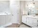 Bright bathroom features a walk-in jacuzzi bathtub, double sink vanity, and tiled flooring at 6439 Bower Dr, Indianapolis, IN 46241