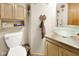 Bathroom features a glass vessel sink, storage, and brick-look tile flooring at 6439 Bower Dr, Indianapolis, IN 46241