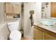Bathroom features a glass vessel sink, storage, and brick-look tile flooring at 6439 Bower Dr, Indianapolis, IN 46241