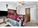 Bedroom featuring a large wooden bed, ceiling fan, and a closet for storing clothes and accessories at 6439 Bower Dr, Indianapolis, IN 46241