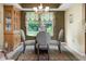 Dining room showcases a glass table set, ornate cabinet, and decorative window treatment at 6439 Bower Dr, Indianapolis, IN 46241