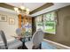 Dining room with table set, china cabinet, and large window overlooking the yard at 6439 Bower Dr, Indianapolis, IN 46241
