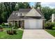 Charming home with a two-car garage, well-manicured lawn, and inviting curb appeal at 6439 Bower Dr, Indianapolis, IN 46241