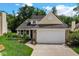 A home's exterior is captured with a two-car garage and landscaped front yard at 6439 Bower Dr, Indianapolis, IN 46241