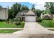 Inviting home exterior with a manicured front yard, driveway leading to a spacious two-car garage at 6439 Bower Dr, Indianapolis, IN 46241