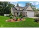 A well-maintained front yard featuring a fountain and manicured landscaping complements this home at 6439 Bower Dr, Indianapolis, IN 46241