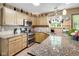 Well-lit kitchen with granite countertops, stainless steel appliances, and tile backsplash at 6439 Bower Dr, Indianapolis, IN 46241