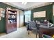 Office features a wooden bookcase, desk, and closet space, ideal for work or study at 6439 Bower Dr, Indianapolis, IN 46241