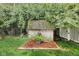 Backyard shed surrounded by landscaping, offering storage and blending with the natural environment at 6439 Bower Dr, Indianapolis, IN 46241