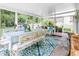 Sunroom with table, chairs and floral decor and outdoor views at 6439 Bower Dr, Indianapolis, IN 46241