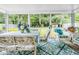 Sunroom with table, chairs and floral decor and garden views at 6439 Bower Dr, Indianapolis, IN 46241