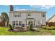 A vast backyard featuring a custom outdoor patio with ample seating, a grill, and luscious green lawn at 6622 W Dickens Xing, McCordsville, IN 46055